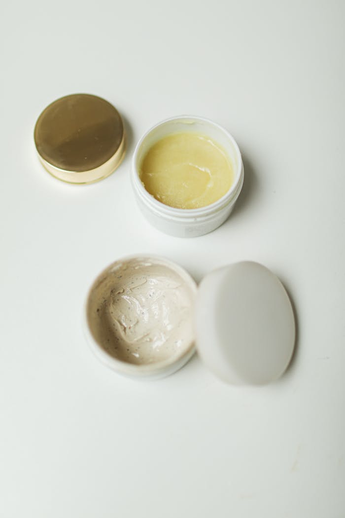 High-angle shot of skincare cream containers for self-care and beauty routines.
